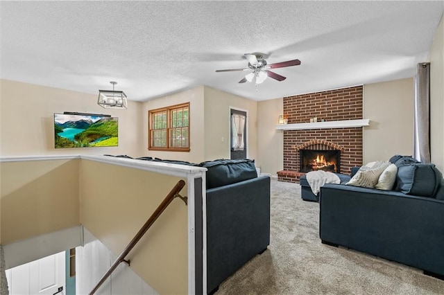 carpeted living area featuring a ceiling fan, a brick fireplace, and a textured ceiling