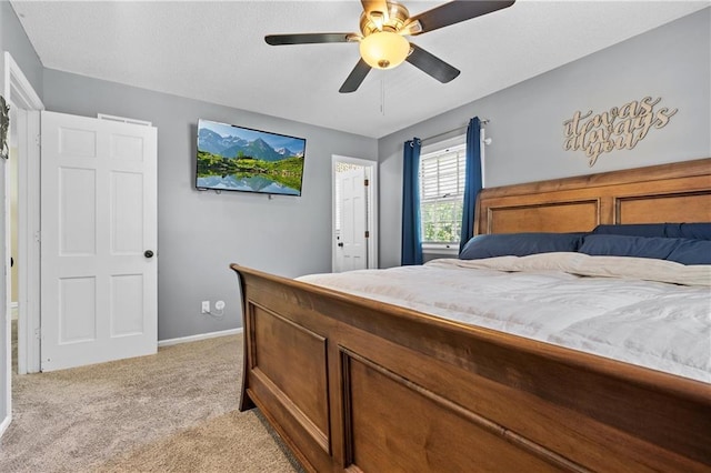 bedroom featuring light carpet, a ceiling fan, and baseboards