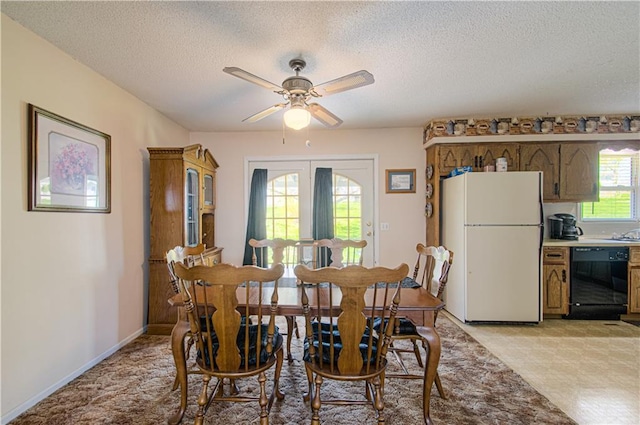 dining space with ceiling fan, a textured ceiling, and baseboards