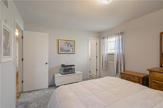 carpeted bedroom featuring a textured ceiling