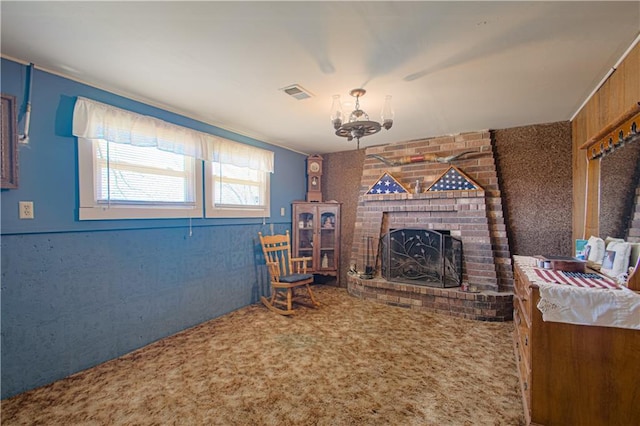 living area featuring a chandelier, carpet flooring, and a brick fireplace
