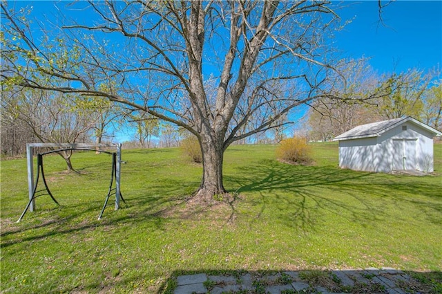 view of grassy yard with an outbuilding and a shed