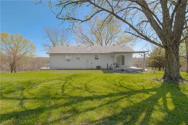 back of property with a yard and a patio