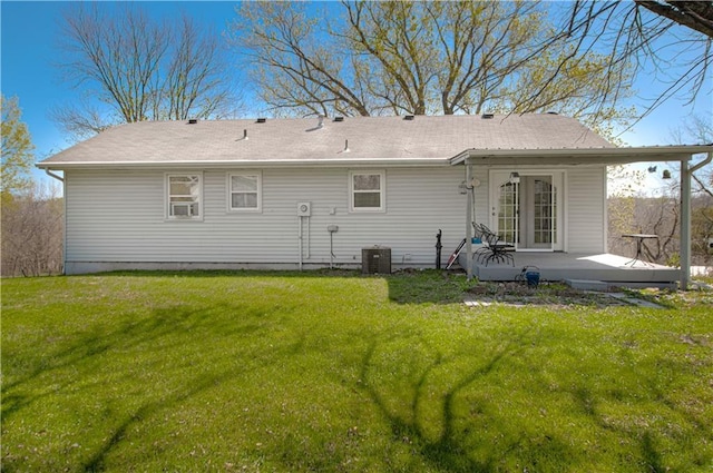 back of house with a lawn and central AC unit