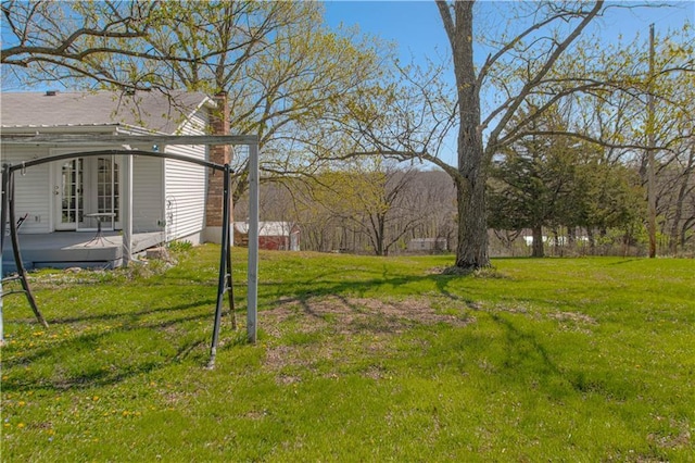 view of grassy yard featuring a wooden deck