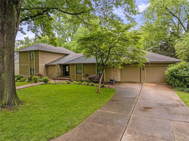 12500 Overbrook Rd, Leawood, KS 66209 - view of front of property with stucco siding, a garage, driveway, and a front yard