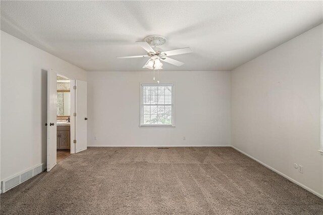 12500 Overbrook Rd, Leawood, KS 66209 - carpeted spare room with ceiling fan, baseboards, and a textured ceiling