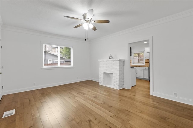 805 N 18th St, Kansas City, KS 66102 - unfurnished living room featuring healthy amount of natural light, ceiling fan, crown molding, light wood-type flooring, and a fireplace