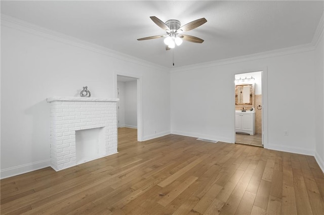805 N 18th St, Kansas City, KS 66102 - unfurnished living room featuring a ceiling fan, crown molding, light wood finished floors, baseboards, and a fireplace