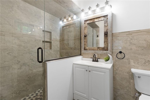 805 N 18th St, Kansas City, KS 66102 - full bathroom featuring tile walls, a stall shower, toilet, and vanity