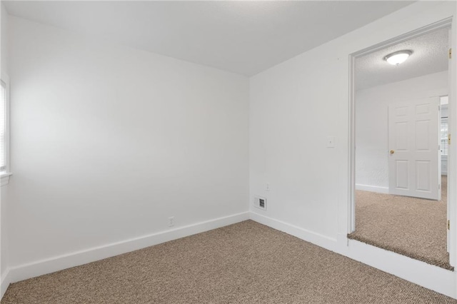 805 N 18th St, Kansas City, KS 66102 - carpeted empty room with baseboards