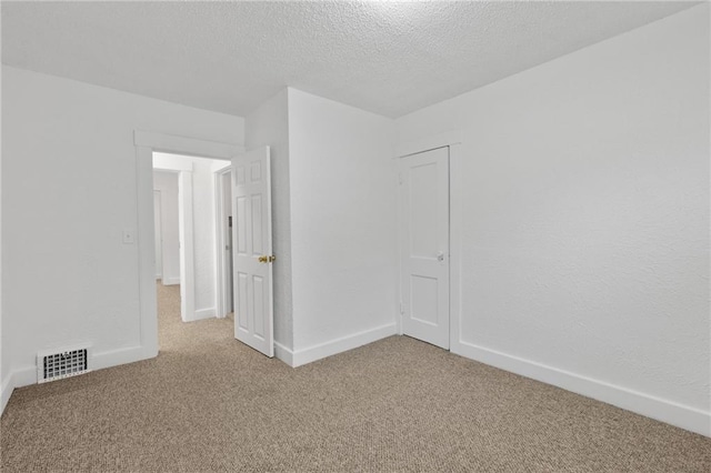 805 N 18th St, Kansas City, KS 66102 - unfurnished room featuring carpet floors, baseboards, and a textured ceiling