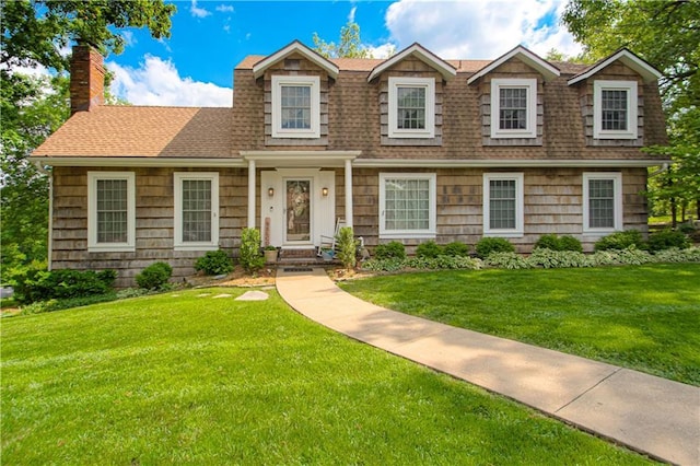 13605 W 48th St, Shawnee, KS 66216 - view of front facade featuring roof with shingles, a front lawn, and a chimney