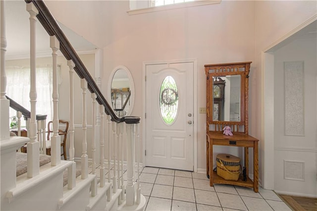 13605 W 48th St, Shawnee, KS 66216 - foyer entrance featuring healthy amount of natural light, stairway, light tile patterned flooring, and a high ceiling
