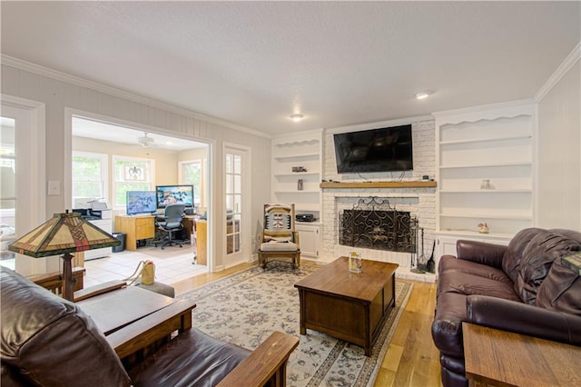 13605 W 48th St, Shawnee, KS 66216 - living room with ornamental molding, built in features, light wood-type flooring, a brick fireplace, and a desk