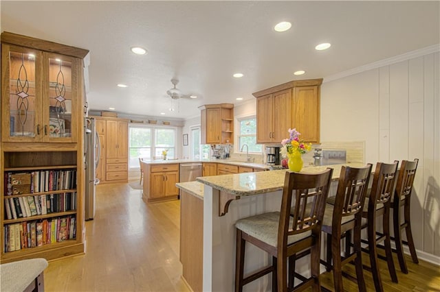 13605 W 48th St, Shawnee, KS 66216 - kitchen with a peninsula, stainless steel appliances, ornamental molding, light wood-style floors, and recessed lighting