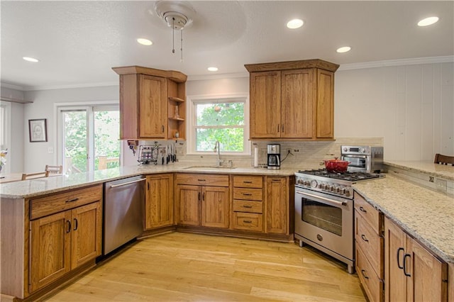 13605 W 48th St, Shawnee, KS 66216 - kitchen with appliances with stainless steel finishes, a peninsula, a sink, light wood-type flooring, and crown molding