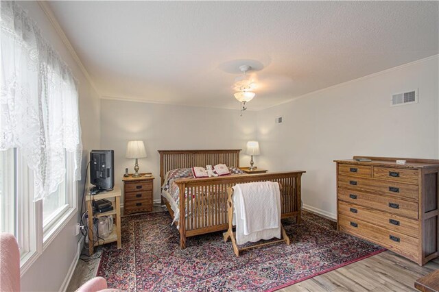 13605 W 48th St, Shawnee, KS 66216 - bedroom with wood finished floors, ornamental molding, and baseboards