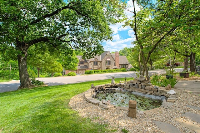 13605 W 48th St, Shawnee, KS 66216 - view of grassy yard with a small pond