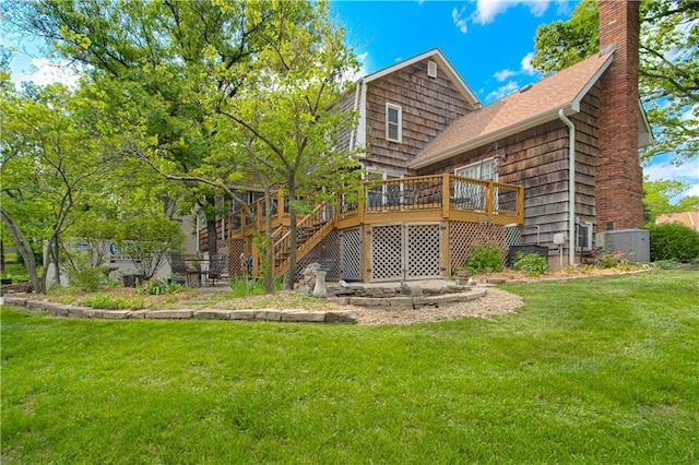 13605 W 48th St, Shawnee, KS 66216 - rear view of house featuring a lawn, a chimney, a deck, and stairs
