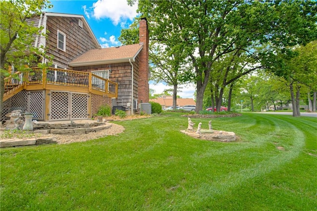 13605 W 48th St, Shawnee, KS 66216 - view of green lawn featuring a wooden deck and central AC