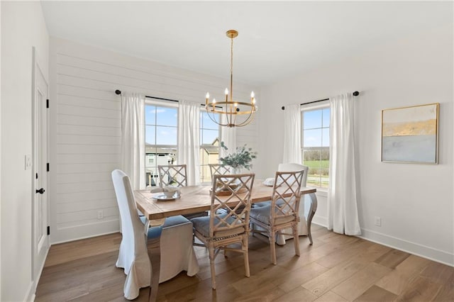 8016 Round Prairie St, Shawnee, KS 66220 - dining space with wood finished floors, a chandelier, and baseboards
