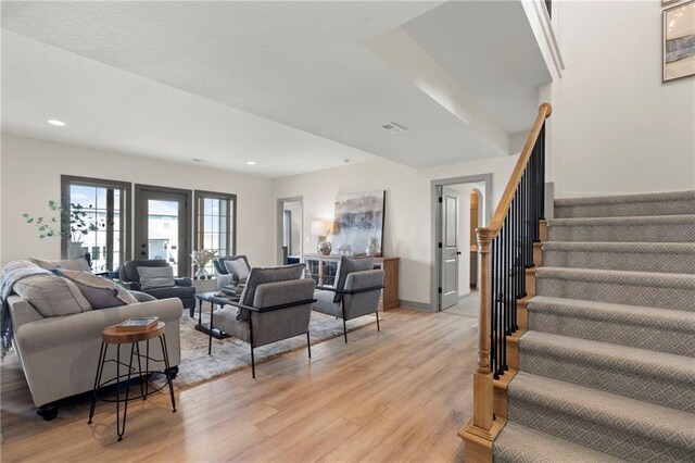 8016 Round Prairie St, Shawnee, KS 66220 - living area featuring visible vents, recessed lighting, stairs, and light wood-style floors