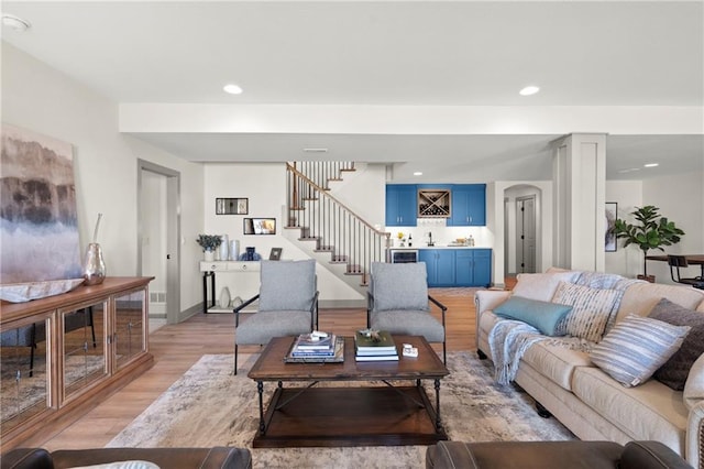 8016 Round Prairie St, Shawnee, KS 66220 - living room with recessed lighting, stairs, indoor bar, and light wood-style floors