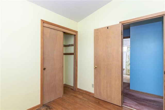 unfurnished bedroom with wood finished floors and a closet