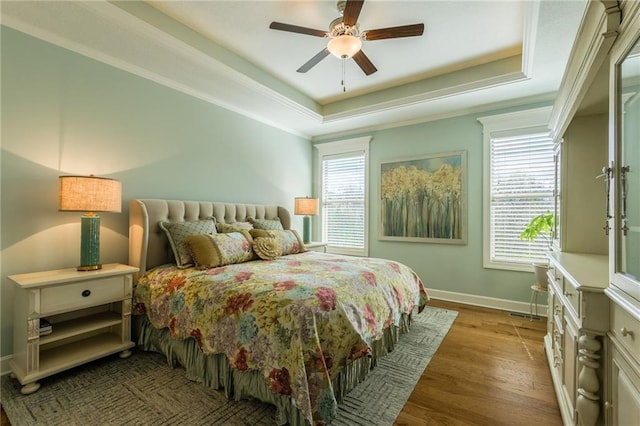420 NW Kaylea Ct, Lees Summit, MO 64081 - bedroom featuring a tray ceiling, wood finished floors, crown molding, and a ceiling fan