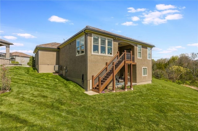 420 NW Kaylea Ct, Lees Summit, MO 64081 - rear view of property with stairway, a lawn, and stucco siding