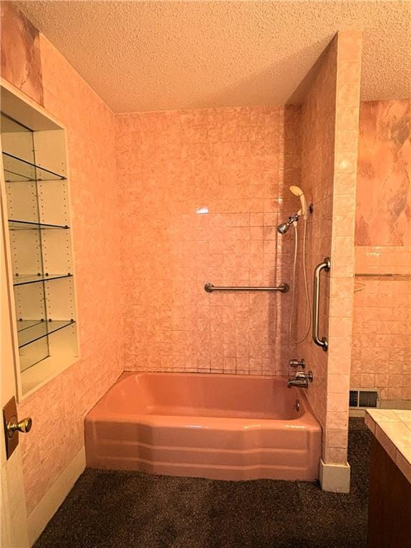 214 W 5th St, Lebo, KS 66856 - bathroom featuring tile walls, bathing tub / shower combination, a textured ceiling, and vanity