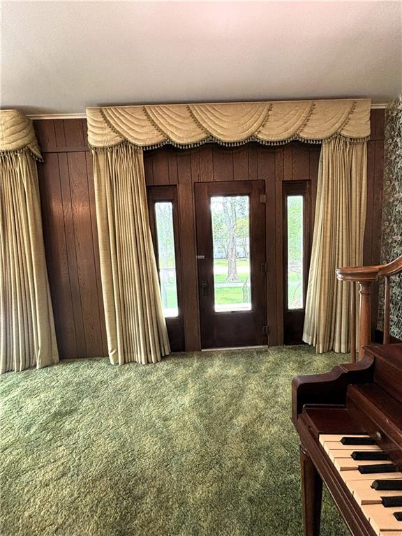 214 W 5th St, Lebo, KS 66856 - carpeted foyer with wood walls and stairs