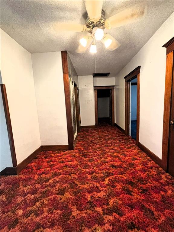 214 W 5th St, Lebo, KS 66856 - hall with carpet flooring and a textured ceiling