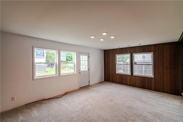 717 Y St, Atchison, KS 66002 - empty room featuring carpet flooring, recessed lighting, and wood walls