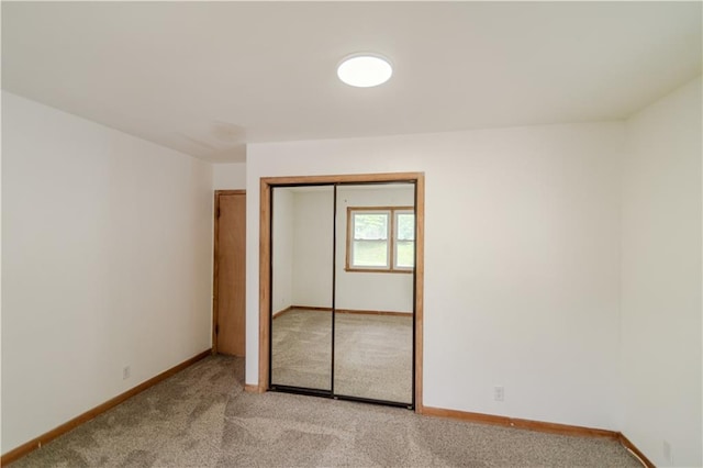 717 Y St, Atchison, KS 66002 - unfurnished bedroom featuring light colored carpet, baseboards, and a closet