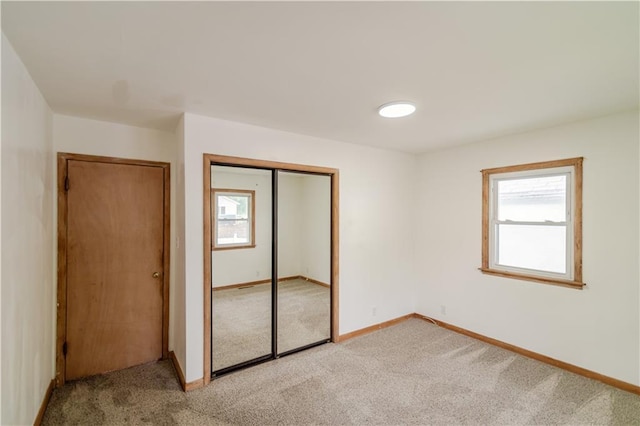 717 Y St, Atchison, KS 66002 - unfurnished bedroom with light carpet, a closet, and baseboards