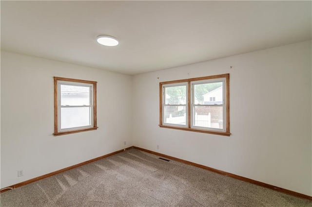 717 Y St, Atchison, KS 66002 - carpeted empty room featuring plenty of natural light and baseboards