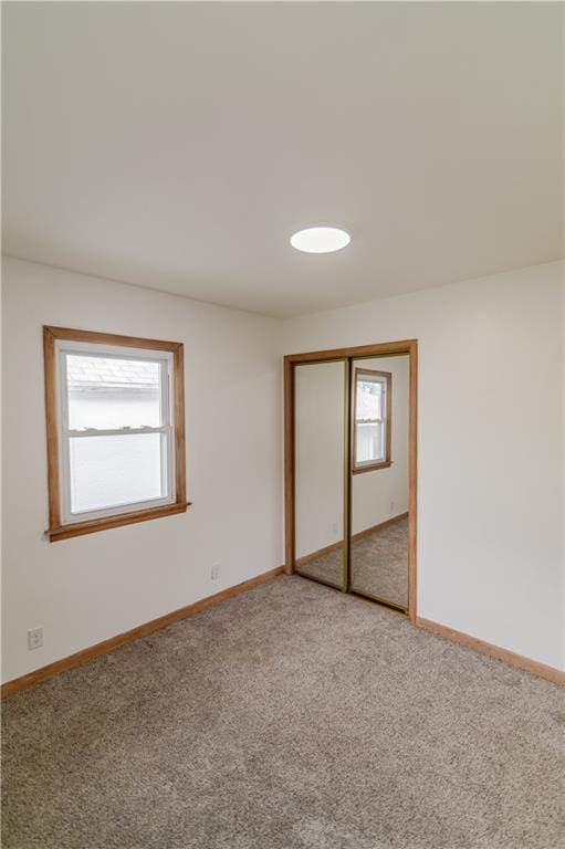 717 Y St, Atchison, KS 66002 - unfurnished bedroom with carpet, baseboards, and a closet