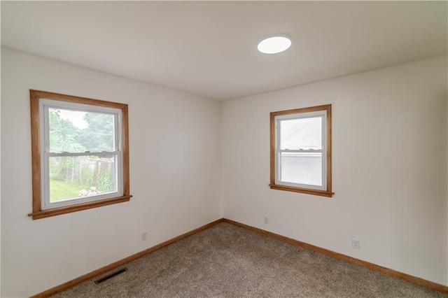 717 Y St, Atchison, KS 66002 - unfurnished room featuring healthy amount of natural light, carpet flooring, and baseboards