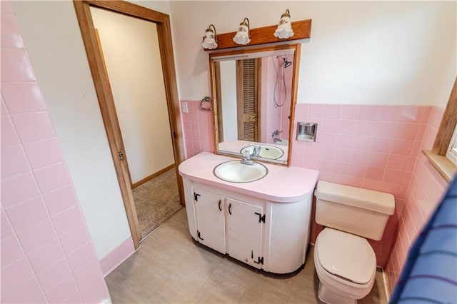 717 Y St, Atchison, KS 66002 - bathroom with tile walls, vanity, toilet, and wainscoting