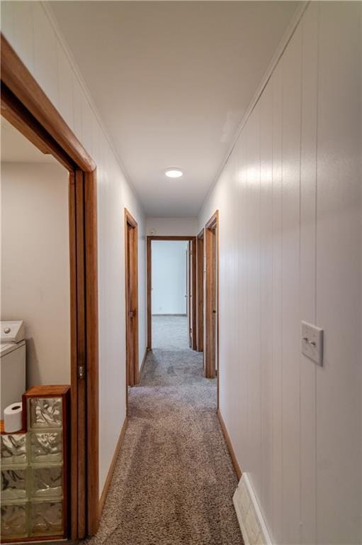 717 Y St, Atchison, KS 66002 - hall with light colored carpet, washer / clothes dryer, and baseboards