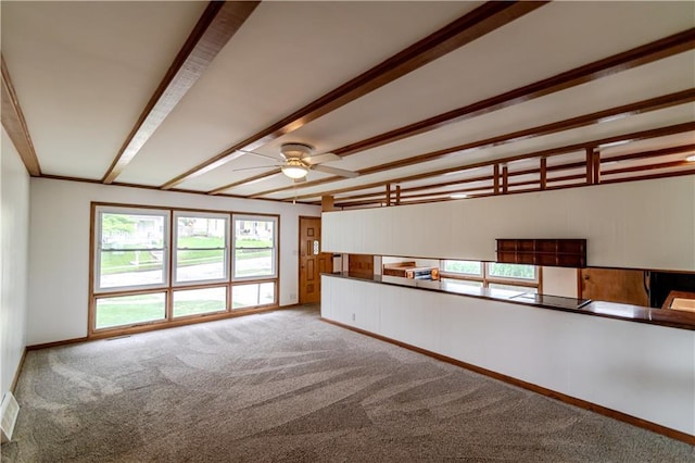 717 Y St, Atchison, KS 66002 - carpeted empty room featuring ceiling fan, beamed ceiling, and baseboards
