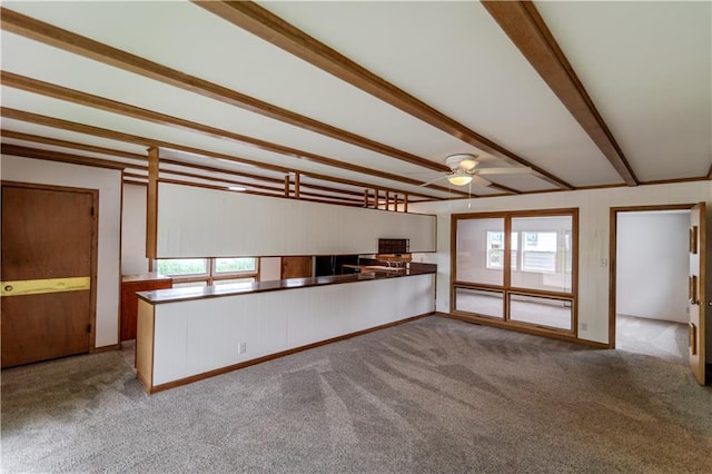 717 Y St, Atchison, KS 66002 - unfurnished living room featuring carpet, beam ceiling, and a ceiling fan