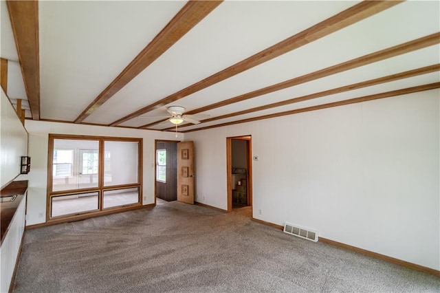 717 Y St, Atchison, KS 66002 - unfurnished living room with carpet flooring, beam ceiling, a ceiling fan, and baseboards