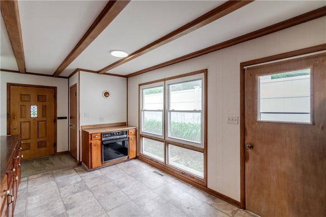 717 Y St, Atchison, KS 66002 - unfurnished living room with baseboards and beamed ceiling