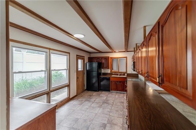 717 Y St, Atchison, KS 66002 - kitchen with black appliances, beam ceiling, brown cabinets, dark countertops, and stone finish floors
