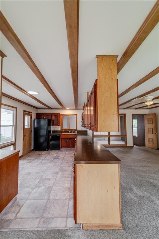 717 Y St, Atchison, KS 66002 - kitchen featuring black appliances, beamed ceiling, plenty of natural light, ceiling fan, and a sink