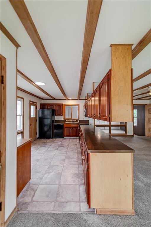 717 Y St, Atchison, KS 66002 - kitchen with black appliances, beam ceiling, dark countertops, and brown cabinetry