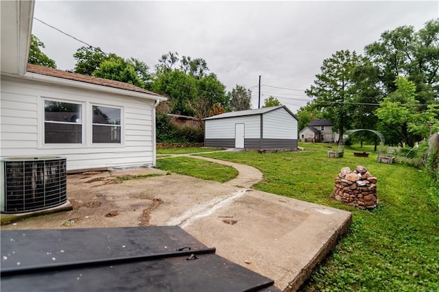 717 Y St, Atchison, KS 66002 - view of grassy yard featuring cooling unit, a patio area, and an outdoor structure